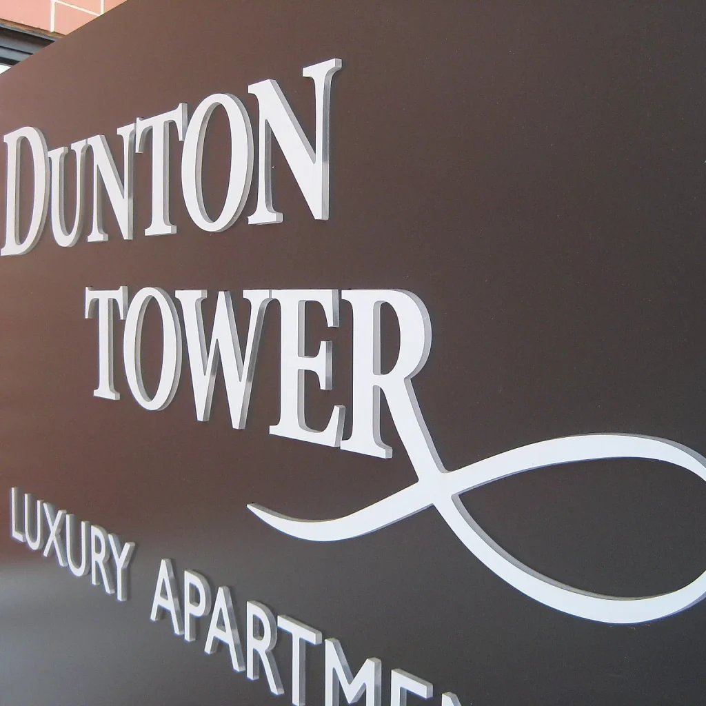 White 3D lettering on black wall for an apartment complex